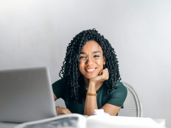 happy-ethnic-woman-sitting-at-table-with-laptop-3769021.jpg